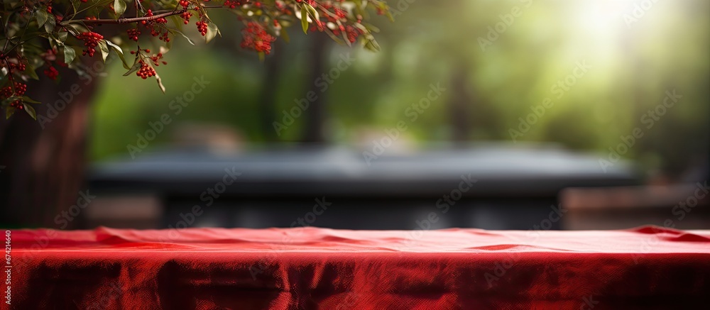 Canvas Prints The place setting includes a worn out tree and a red napkin with a blurred background grill