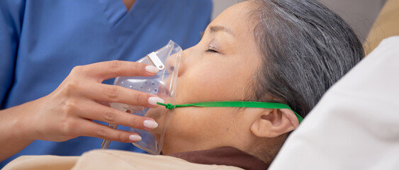 Nurse putting oxygen mask with patient elderly woman on bed for diagnose and healing in hospital,...