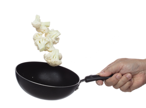 Cauliflower fly fall in pan, green fresh vegetable Cauliflower cut chop slice. Organic fresh vegetable Cauliflower, close up texture. White background isolated freeze motion high speed shutter