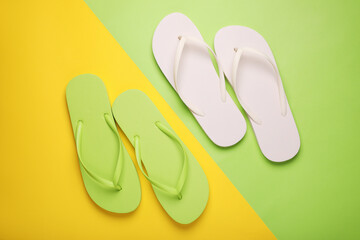 Different stylish flip flops on color background, flat lay