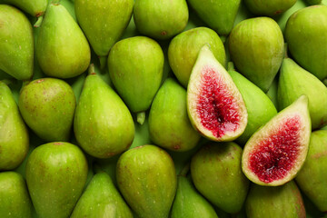 Halves of green fig on fresh fruits, top view