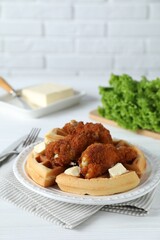 Delicious Belgium waffles served with fried chicken and butter on white table, space for text