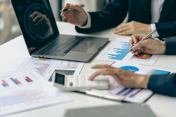 business team working They are analyzing financial reports and using calculators. accounting calculations And partners point to financial reports to analyze the company's sales plans. - obrazy, fototapety, plakaty