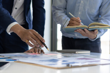 business team working They are analyzing financial reports and using calculators. accounting...