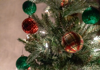 Obraz na płótnie Canvas Close up of hanging Christmas tree ornaments and bright white lights