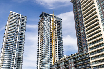 High-rise buildings - blue sky - construction crane © Jacob Tian