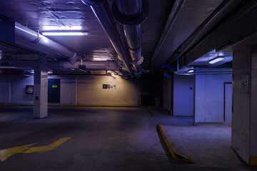 Empty parking garage - underground - yellow lines - pipes - concrete walls