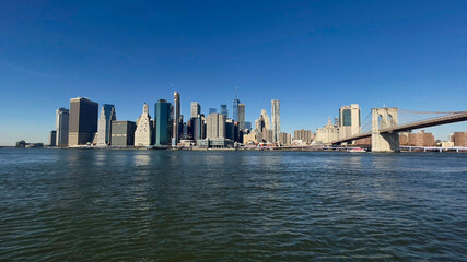 Panoramic view of Manhattan skyline and Brooklyn Bridge shot on a beautiful day in November 2023