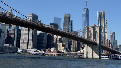 Fototapeta na wymiar Panoramic view of Manhattan skyline and Brooklyn Bridge shot on a beautiful day in November 2023