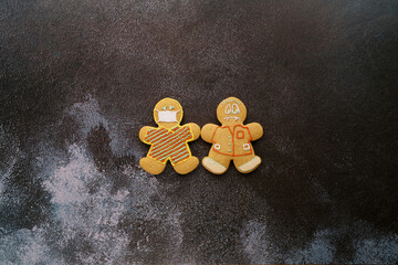 Gingerbread men centered on a black shabby background