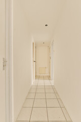 an empty room with white walls and tile flooring on the right side of the room, there is a door in the middle