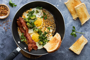 Cheddar cheese fried eggs, served with a garlic herb salad, bacon and toast.