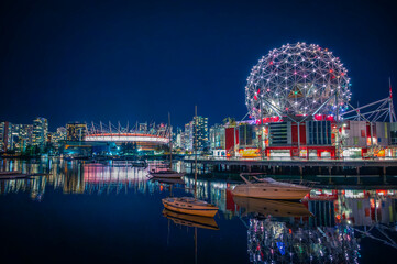 Skyline of downtown Vancouver, BC Place Stadium and Science World museum at night with light...