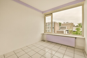 an empty room with white tiles and purple trim around the window panes, looking out onto the street below