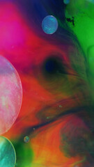 Glitter bubbles. Color mist. Paint water. Defocused bright pink green blue gradient smoke texture round ink sphere floating art abstract background.