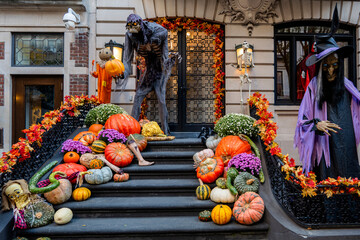 Colorful Pumpkins and Flowers on the Stairs of an Old Brownstone Home in New York City during...