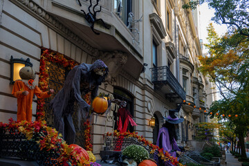 Colorful Pumpkins and Flowers on the Stairs of an Old Brownstone Home in New York City during...