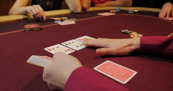 Playing cards in a casino. Close-up of a female hand holding a card