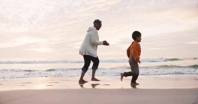 Beach, happy and grandmother running with child in the water at sea excited for holiday or outdoor vacation together. Adventure, travel and grandma bonding kid or boy by the ocean at sunset in summer