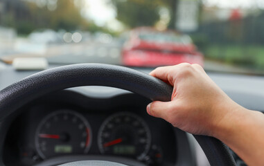 hands gripping a steering wheel, symbolizing control, focus, and safety while driving