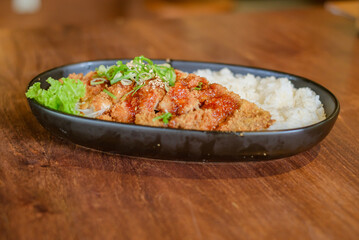 Chicken Katsu Curry is a dish of crispy chicken pieces served over rice with Japanese curry sauce.
