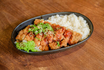 Chicken Katsu Curry is a dish of crispy chicken pieces served over rice with Japanese curry sauce.