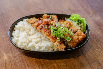 Chicken Katsu Curry is a dish of crispy chicken pieces served over rice with Japanese curry sauce.