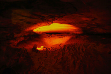 Red light illuminating cave walls in Mammoth Cave National Park