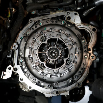 closeup of a full clutch assembly mounted on the engine transmission line of a vehicle brought for regular service in the workshop