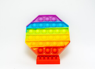 Rainbow octagone shaped pot it toys isolated on white background. Sensory Silicone Toys for Autism, Fidget Popper, Anti Anxiety and Stress Relief Game.
