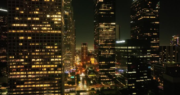 Night aerial view of downtown Los Angeles, California. Downtown Los Angeles at night from drone. Night illuminated flight over Los Angeles city downtown panorama. Los Angeles night buildings skyline.