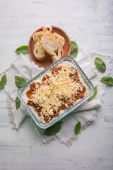 Bolognese and pesto frozen Lasagna on metal Tray for food delivery