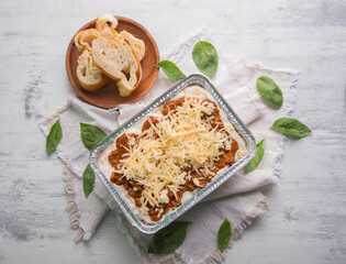 Bolognese and pesto frozen Lasagna on metal Tray for food delivery