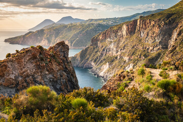 Eye-catching landscape of Lipari island at sunset time captured from the top of the mountain cliffs over the sea in Sicily, Italy