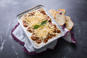 Bolognese and pesto frozen Lasagna on metal Tray for food delivery