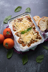 Bolognese and pesto frozen Lasagna on metal Tray for food delivery
