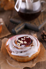 Pastries and coffee in a drip bag on a wooden table.