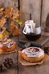 Pastries and coffee in a drip bag on a wooden table.