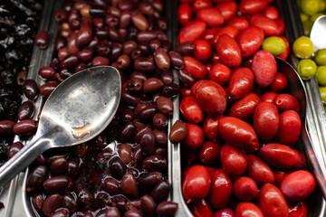 olives in a tray with big spoon 