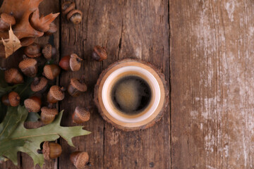 Small portion of coffee and acorns on a wooden table