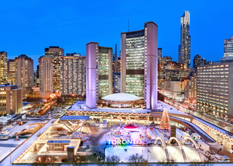 Toronto City Hall with skating rink at Nathan Phillips Square in winter