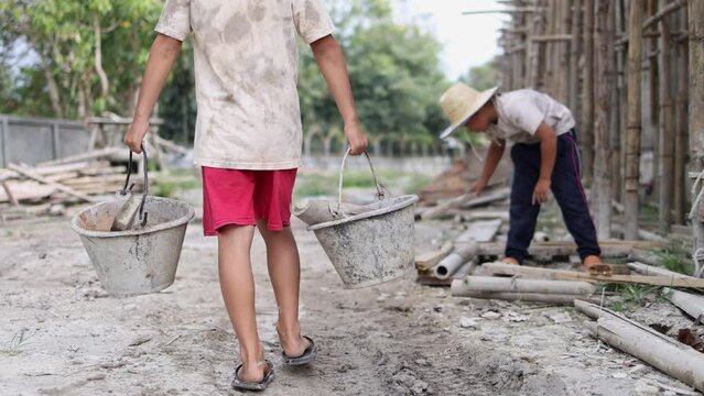 Children working at construction site.  Poor children are forced to work in construction, Violence children and trafficking concept, Rights Day, World Day Against Child Labour concept