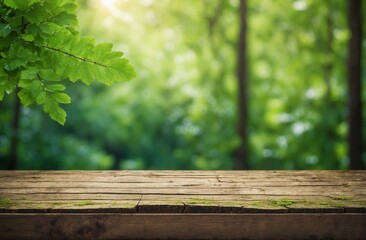 Table top wood texture with green leaves and blurred green nature background