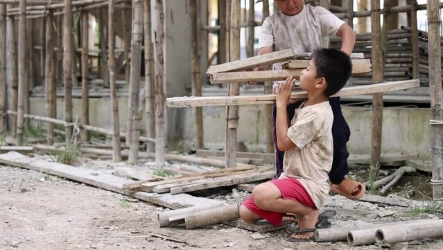 Poor children at the construction site were forced to work. Concept against child labor. The oppression or intimidation of forced labor among children. Human trafficking.