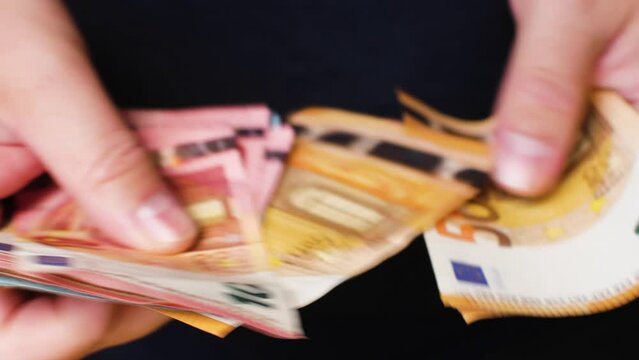 Man Counts Euro Banknotes in Hand