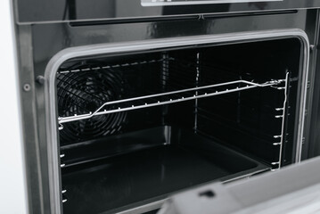Side view of an open electric oven inside, selective focus