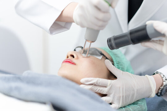 Woman receiving pico laser facial treatment in beauty Clinic.