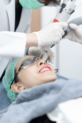 Fototapeta premium Woman receiving pico laser facial treatment in beauty Clinic.