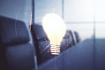 Abstract virtual light bulb hologram on a modern boardroom background, idea concept. Multiexposure