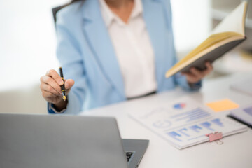 Close-up shot of Asian woman working with laptop in her office business finance concept